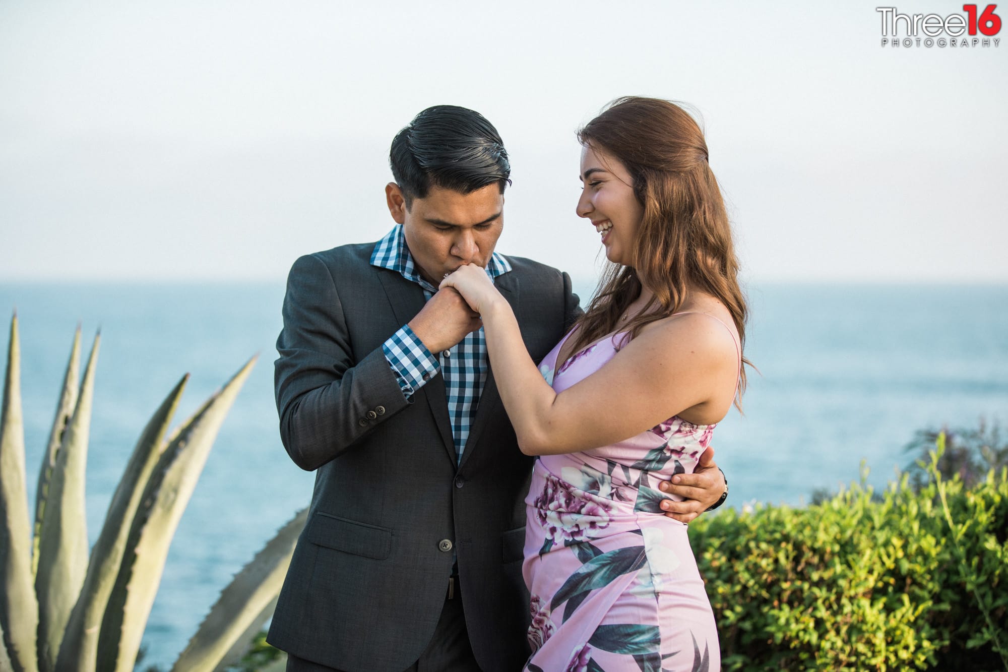 Groom kisses brides hand after proposing at Laguna beach