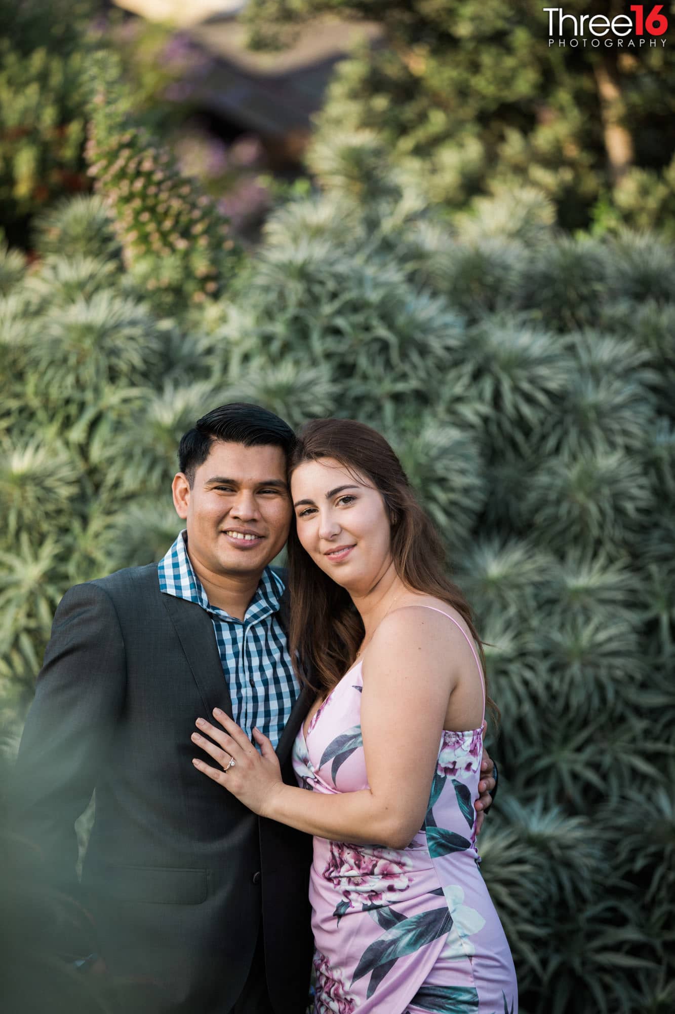 Newly engaged couple pose for wedding photographer